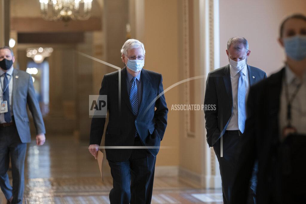 J. Scott Applewhite On the first full day of the new Democratic majority in the Senate, Sen. Mitch McConnell, R-Ky., the top Republican, walks to the chamber for the start of business as the minority leader, at the Capitol in Washington, Thursday, Jan. 21, 2021. There is now a 50-50 split between Republicans and Democrats, but with Democratic Vice President Kamala Harris as the tie-breaker, the majority shifts by the slimmest of margins. (AP Photo/J. Scott Applewhite)