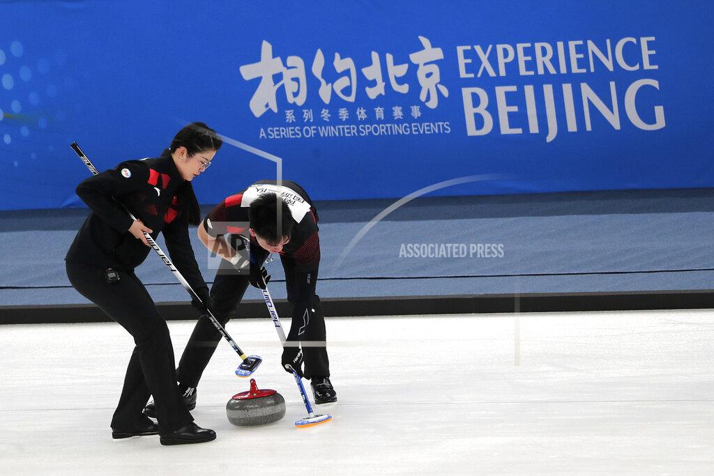 Andy Wong Local team players compete in a curling competition during a test event for the 2022 Beijing Winter Olympics at National Aquatic Center, also known as the "Water Cube" in Beijing, Thursday, April 1, 2021. Chinese capital hold a 10 days test events for 2022 Beijing Winter Olympics in five different venues from April 1-10, becomes the first city to hold both the Winter and Summer Olympics. (AP Photo/Andy Wong)