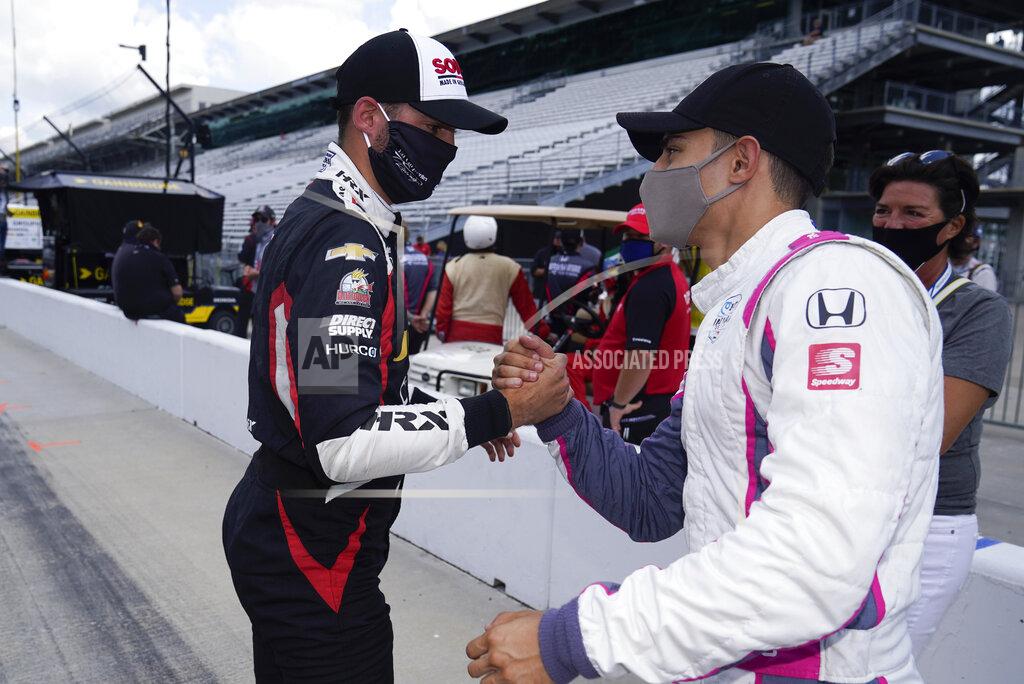 Darron Cummings Rinus VeeKay, left, of the Netherlands, and Alex Palou, of Spain, shake hands after they qualified for the Indianapolis 500 auto race at Indianapolis Motor Speedway, Sunday, Aug. 16, 2020, in Indianapolis. (AP Photo/Darron Cummings)