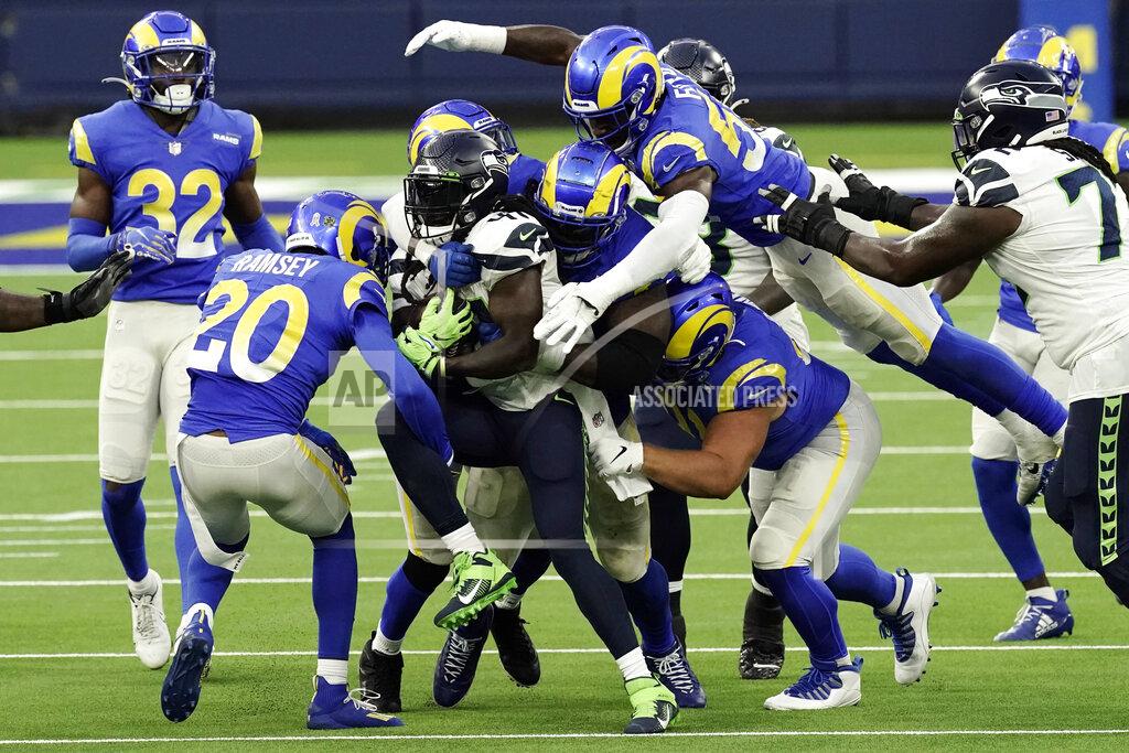 Jae C. Hong Seattle Seahawks running back Alex Collins, center, is tackled by a group of Los Angeles Rams defenders during the second half of an NFL football game Sunday, Nov. 15, 2020, in Inglewood, Calif. (AP Photo/Jae C. Hong)