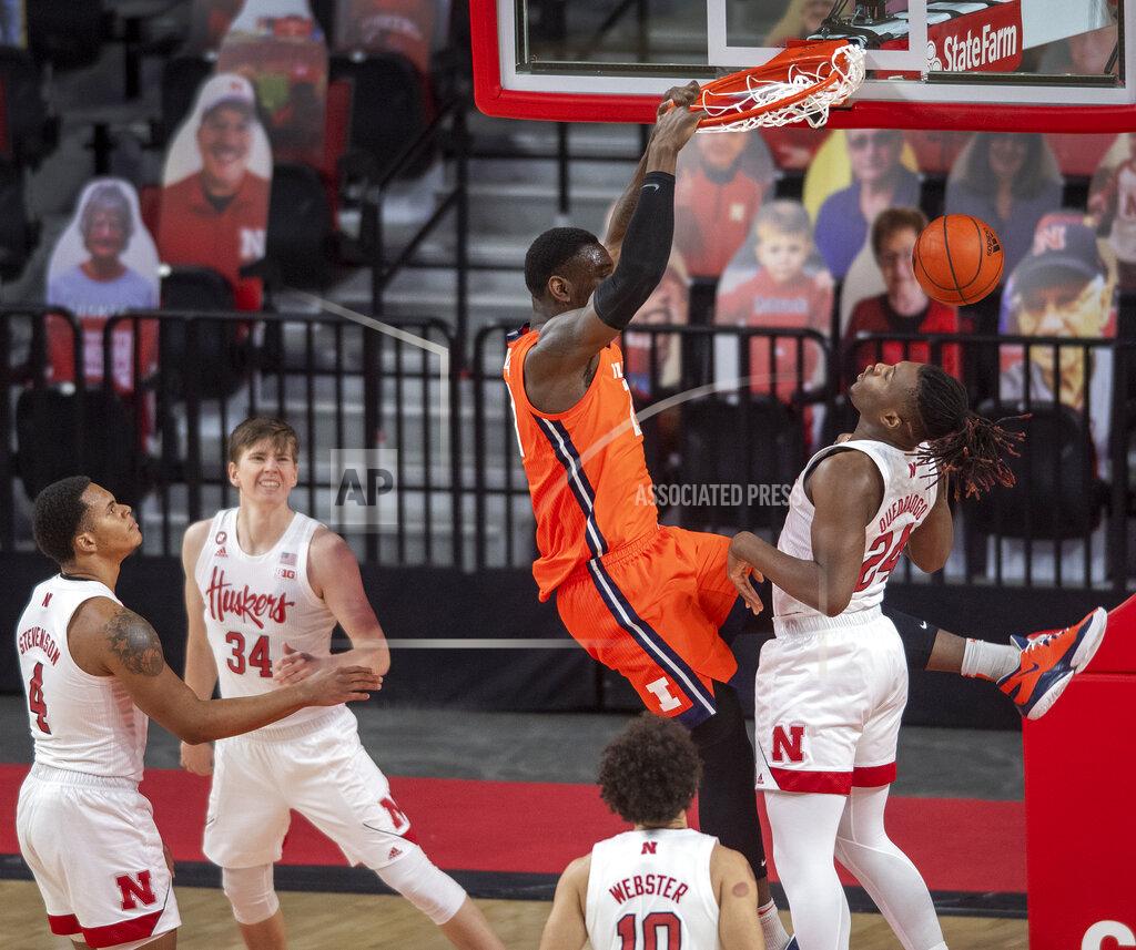 Francis Gardler Illinois' Kofi Cockburn (21) dunks over Nebraska forward Yvan Ouedraogo (24) as Nebraska's Shamiel Stevenson (4), Thorir Thorbjarnarson (34) and Kobe Webster (10) watch during the first half of an NCAA college basketball game on Friday, Feb. 12, 2021, in Lincoln, Neb. (Francis Gardler/Lincoln Journal Star via AP)