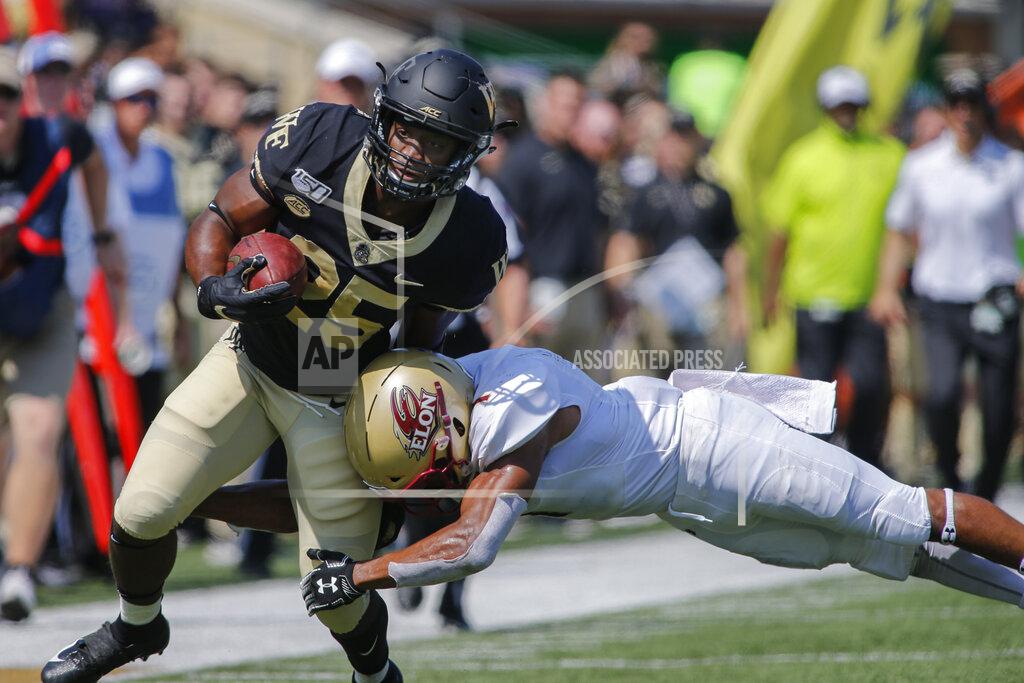 Nell Redmond Wake Forest running back Kenneth Walker III, left, carries the football as Elon defensive back Cole Coleman tackles him in the first half of an NCAA college football game in Winston-Salem, N.C., Saturday, Sept. 21, 2019. (AP Photo/Nell Redmond)
