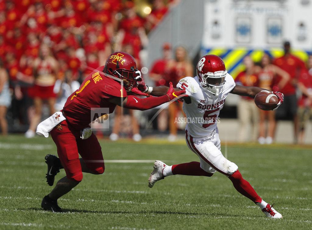 Matthew Putney Oklahoma wide receiver Marquise Brown, right, runs the ball as he fends off Iowa State defensive back D'Andre Payne, left, during the first half of an NCAA college football game, Saturday, Sept. 15, 2018, in Ames. (AP Photo/Matthew Putney)