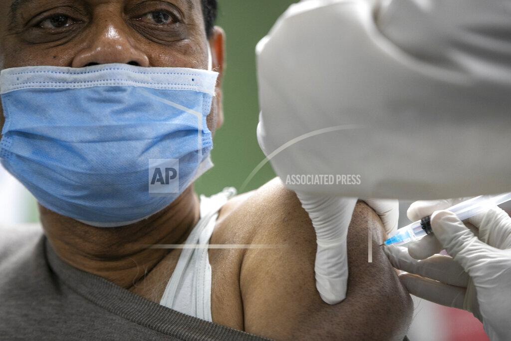 Niranjan Shrestha A Nepalese doctor receives AstraZeneca/Oxford University vaccine, at Teaching Hospital in Kathmandu, Nepal, Wednesday, Jan. 27, 2021. Thousands of health workers lined up across Nepal to get the coronavirus vaccine Wednesday as the Himalayan nation began its campaign to get the population vaccinated within three months. Neighboring India gifted Nepal 1 million doses of the vaccine manufactured under license by the Serum Institute of India. (AP Photo/Niranjan Shrestha)