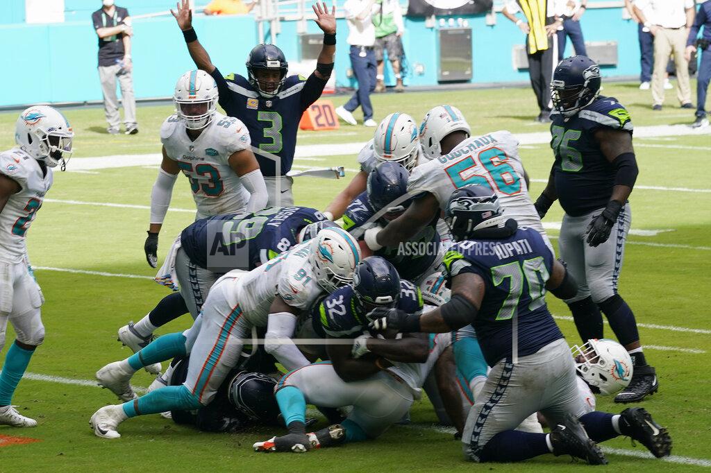 Lynne Sladky Seattle Seahawks running back Chris Carson (32) scores a touchdown during the second half of an NFL football game against the Miami Dolphins, Sunday, Oct. 4, 2020, in Miami Gardens, Fla. The Seahawks defeated the Dolphins 31-23.(AP Photo/Lynne Sladky)