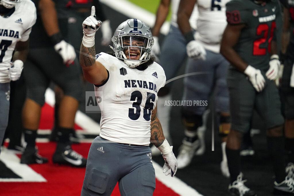 John Locher Nevada running back Toa Taua (35) celebrates after scoring a touchdown against UNLV during the second half of an NCAA college football game Saturday, Oct. 31, 2020, in Las Vegas. (AP Photo/John Locher)
