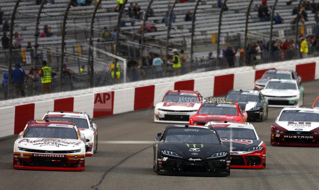 Steve Helber Riley Herbst (18) leads the field at the start of a NASCAR Xfinity Series auto race at Richmond International Raceway in Richmond, Va., Friday, April 12, 2019. (AP Photo/Steve Helber)