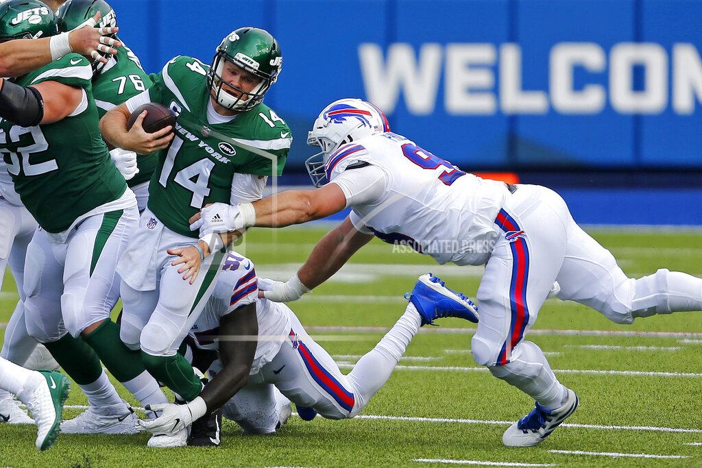 Jeffrey T. Barnes New York Jets quarterback Sam Darnold (14) is sacked by Buffalo Bills defensive end Mario Addison (97), center rear, and Harrison Phillips, right, during the second half of an NFL football game in Orchard Park, N.Y., Sunday, Sept. 13, 2020. (AP Photo/Jeffrey T. Barnes)