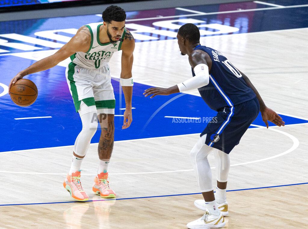 Sam Hodde Boston Celtics forward Jayson Tatum (0) dribbles the ball as Dallas Mavericks forward Dorian Finney-Smith (10) defends during the first half of an NBA basketball game in Dallas, Tuesday, Feb. 23, 2021. (AP Photo/Sam Hodde)