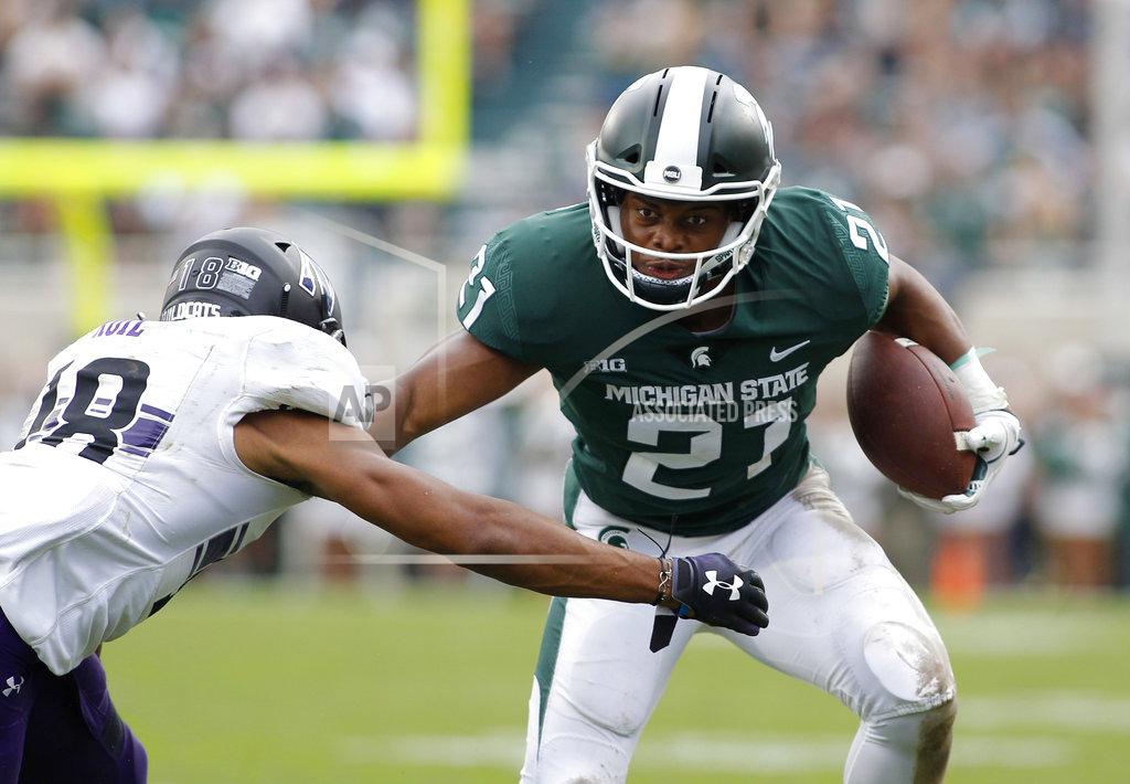 Al Goldis Michigan State's Cam Chambers, right, runs on a pass reception against Northwestern's Cameron Ruiz during the fourth quarter of an NCAA college football game, Saturday, Oct. 6, 2018, in East Lansing, Mich. Northwestern won 29-19. (AP Photo/Al Goldis)