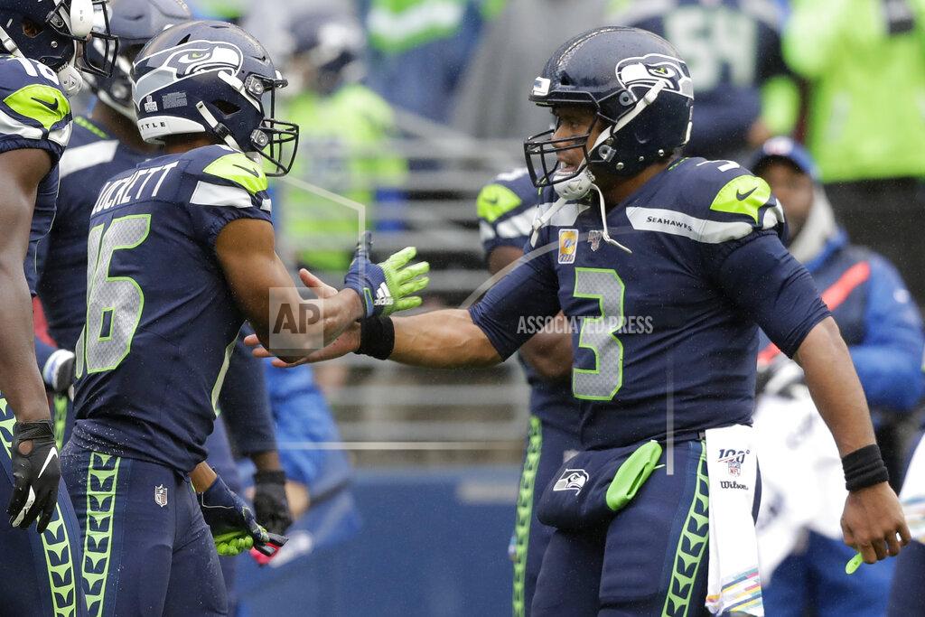 John Froschauer Seattle Seahawks quarterback Russell Wilson (3) greets wide receiver Tyler Lockett (16) after Lockett caught a pass from Wilson for a touchdown against the Baltimore Ravens during the first half of an NFL football game, Sunday, Oct. 20, 2019, in Seattle. (AP Photo/John Froschauer)