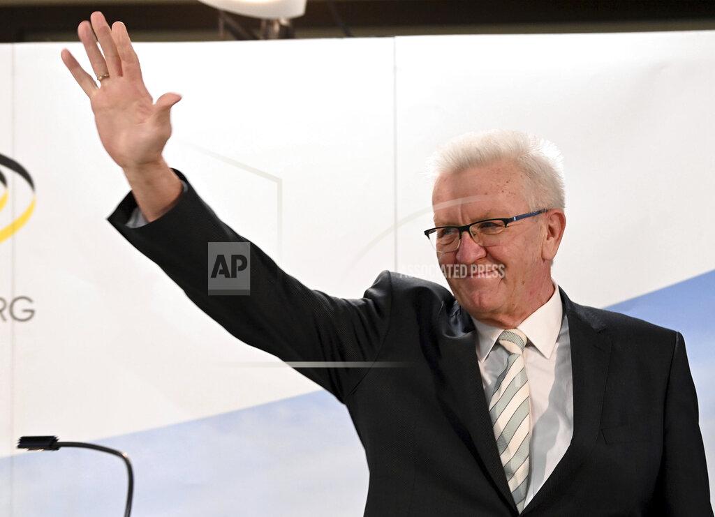 Uli Deck Winfried Kretschmann, Minister President of Baden-Wuerttemberg and top candidate of the Green Party, waves after the announcement of the first results of the state elections in Baden-Wuerttemberg in Stuttgart, Germany, March 14, 2021. Exit polls are pointing to defeats for Chancellor Angela Merkel’s center-right party CDU in two German state elections. (Uli Deck/dpa via AP)