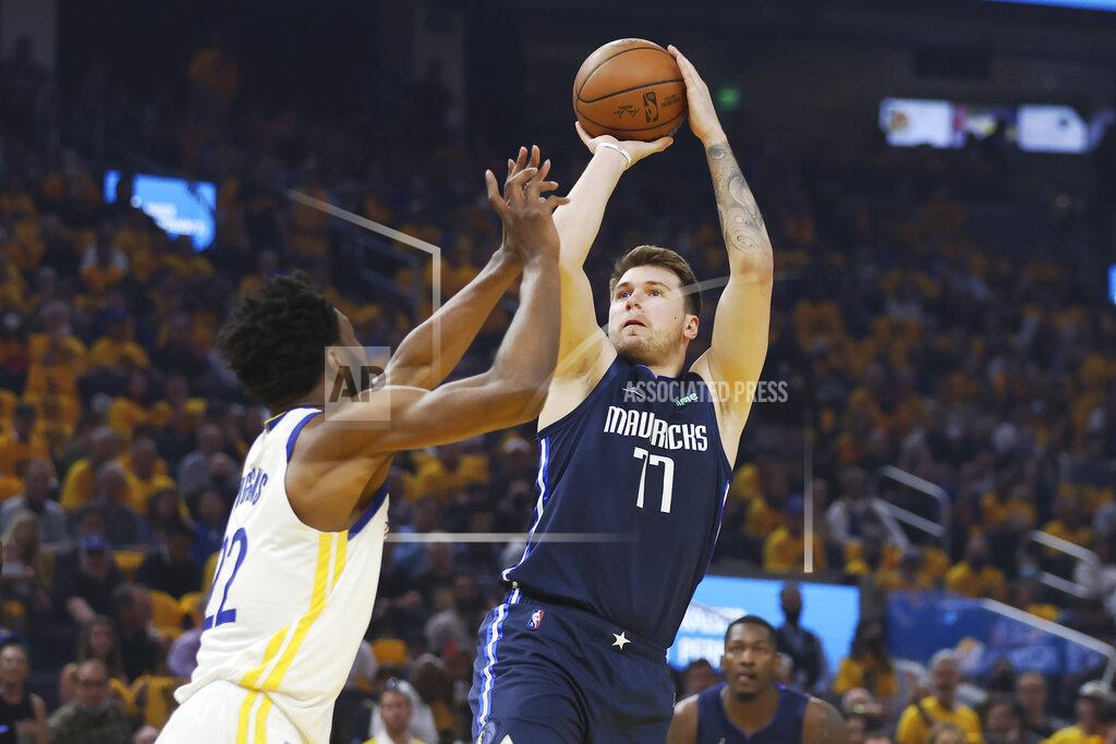 Jed Jacobsohn Dallas Mavericks guard Luka Doncic (77) shoots against Golden State Warriors forward Andrew Wiggins during the first half of Game 2 of the NBA basketball playoffs Western Conference finals in San Francisco, Friday, May 20, 2022. (AP Photo/Jed Jacobsohn)