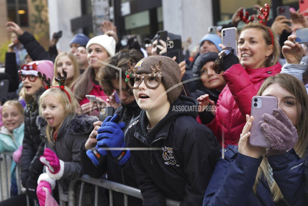 Jeenah Moon Spectators watch floats and balloons pass by on Sixth Avenue during the Macy's Thanksgiving Day Parade, Thursday, Nov. 24, 2022, in New York. (AP Photo/Jeenah Moon)