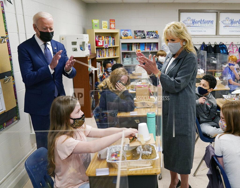 Evan Vucci President Joe Biden and first lady Jill Biden applaud a student as she demonstrates her project, during a visit to Yorktown Elementary School, Monday, May 3, 2021, in Yorktown, Va. (AP Photo/Evan Vucci)