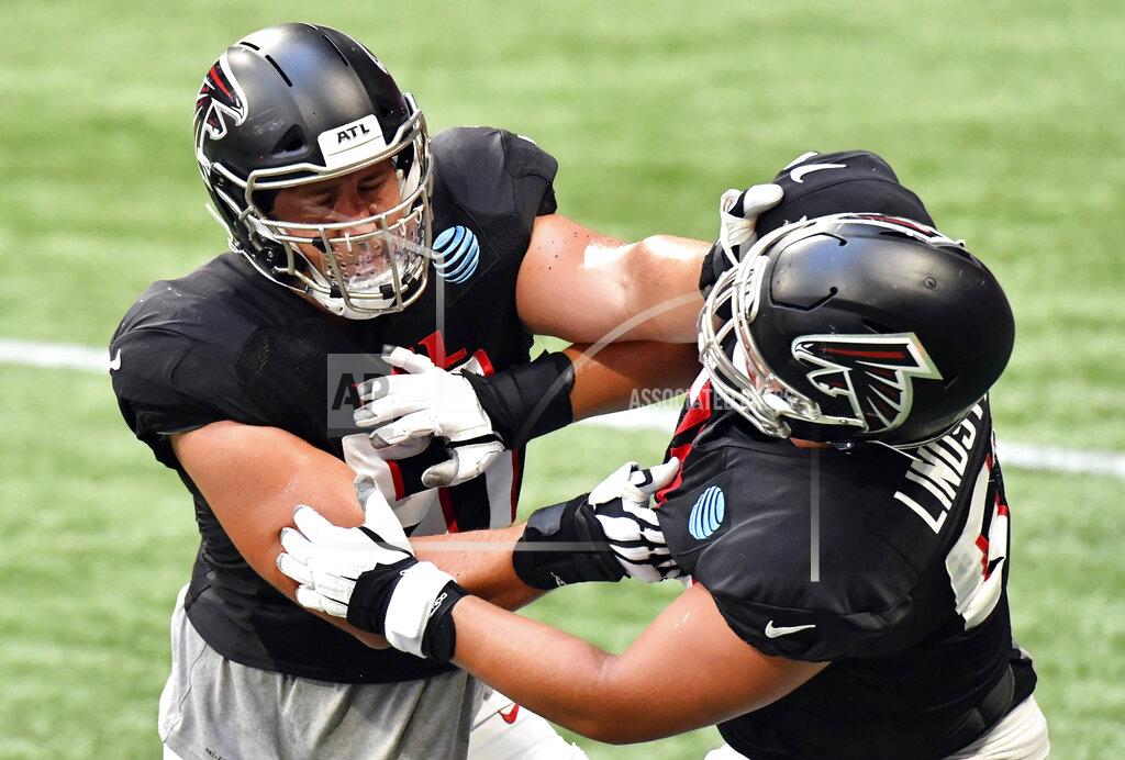 Hyosub Shin Atlanta Falcons center Alex Mack (51) and guard Chris Lindstrom (63) run a drill during an NFL football training camp practice Thursday, Sept. 3, 2020, in Atlanta. (Hyosub Shin/Atlanta Journal-Constitution via AP)
