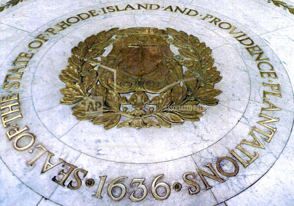 Susan E. Bouchard FILE - This Jan. 21, 2000, file photo shows the seal bearing the official name "State of Rhode Island and Providence Plantations" on the floor of the Statehouse rotunda in Providence, R.I. On Nov. 3, voters approved a ballot question to strip the words "and Providence Plantations" from Rhode Island's formal name. (AP Photo/Susan E. Bouchard, File)