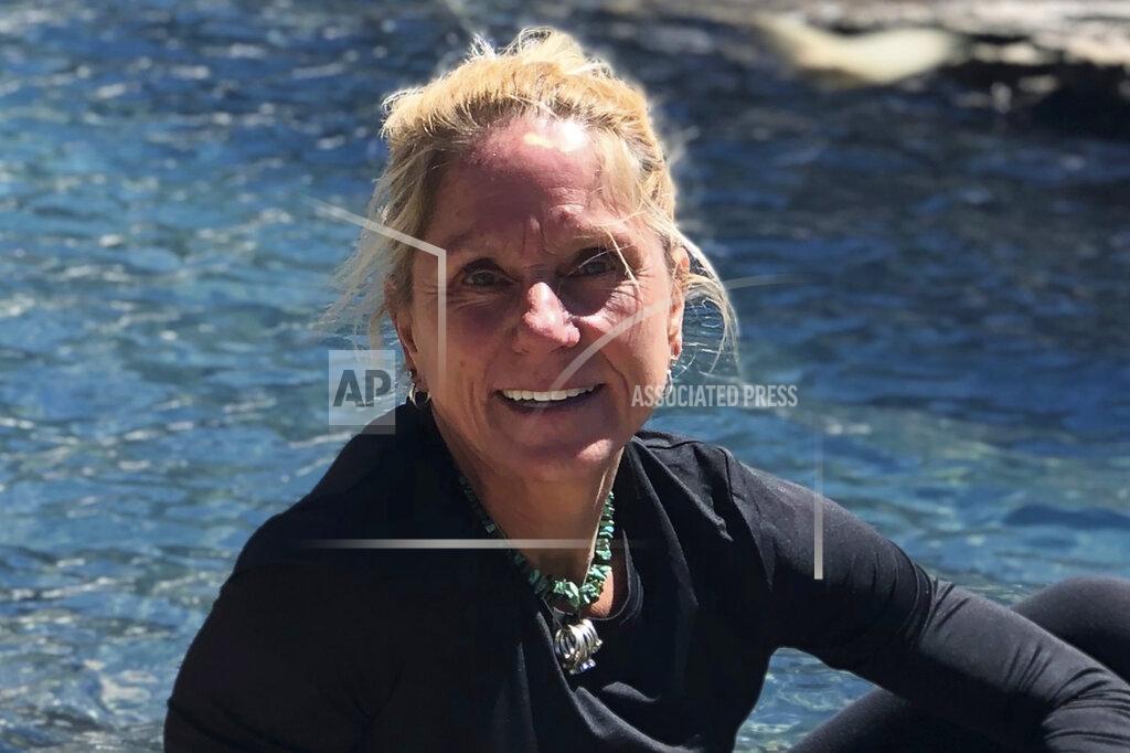 In this undated photo, Saundra Andringa-Meuer poses for photo on a trip in Colorado. Andringa-Meuer, who has recovered from the coronavirus, has joined with dozens of other American virus patients and some U.S. businesses in taking a new legal step: They are attempting to sue China over the spread of the virus, which has killed at least 75,000 people in the United States. (Molly Meuer/Saundra Andringa-Meuer via AP)