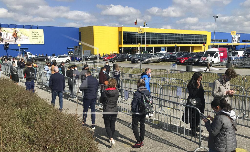 Mark Carlson People stand in line for last minute shopping outside an Ikea store in Brussels, Friday, March 26, 2021. New rules for non-essential shopping begin on Saturday in Belgium as the nation tries to reduce its fast-rising COVID-19 numbers. Beginning Saturday customers will need to book an appointment to be allowed inside all non-essential businesses. (AP Photo/Mark Carlson)