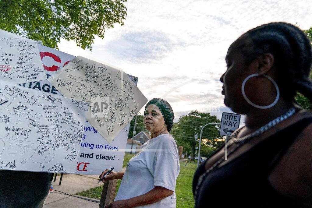 David Goldman Snovia Gosa signs a message on a memorial board for a friend who was killed by gun violence as residents from neighboring blocks attend a 'peace picnic' in the Auburn Gresham neighborhood in Chicago, Saturday, Aug. 22, 2020. Last year, 1,149 guns were recovered from the 6th police district, which includes Auburn Gresham, about 10 percent of the haul for the entire city. As of the end of September, the district had recorded 59 homicides this year, nearly 60 percent higher than the same period last year. (AP Photo/David Goldman)