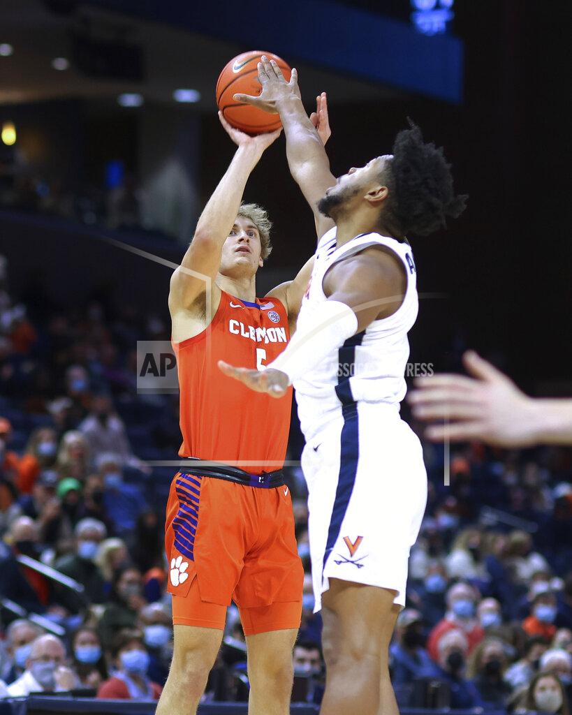 Andrew Shurtleff Clemson forward Hunter Tyson (5) shoots over Virginia forward Jayden Gardner (1) during the first half of an NCAA college basketball game in Charlottesville, Va., Wednesday, Dec. 22, 2021. (AP Photo/Andrew Shurtleff)