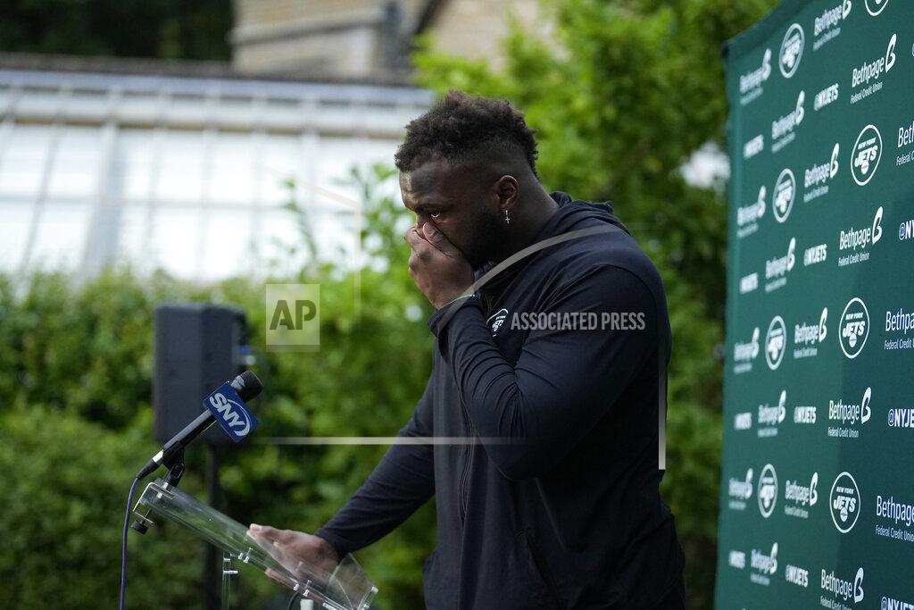 Matt Dunham New York Jets' defensive lineman John Franklin-Myers is overcome with emotion as he speaks about signing his new contract during a press conference after an NFL practice session at Hanbury Manor Marriott Hotel and Country Club near the town of Ware in south east England, Friday, Oct. 8, 2021. The New York Jets are preparing for an NFL regular season game against the Atlanta Falcons in London on Sunday. (AP Photo/Matt Dunham)