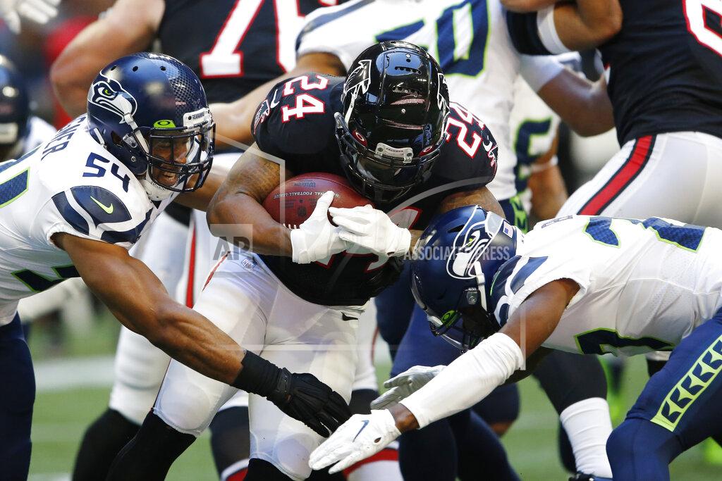 John Bazemore Atlanta Falcons running back Devonta Freeman (24) runs into Seattle Seahawks middle linebacker Bobby Wagner (54) during the first half of an NFL football game, Sunday, Oct. 27, 2019, in Atlanta. (AP Photo/John Bazemore)