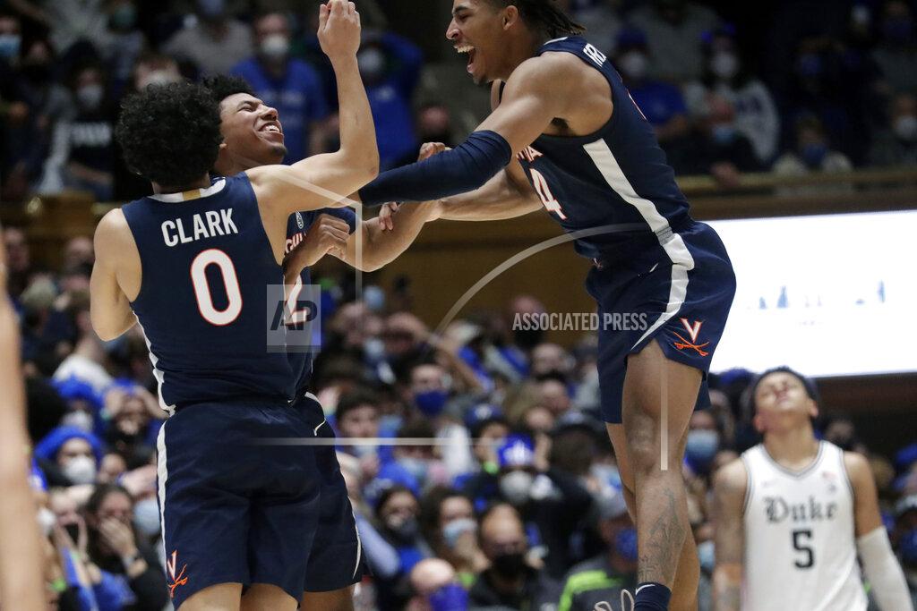 Chris Seward Virginia guard Reece Beekman, second from left, celebrates with teammates and guards Kihei Clark (0) and Armaan Franklin (4) after he hit a 3-point shot with under three seconds for the go-ahead and eventual game-winning points late in the second half of an NCAA college basketball game against Duke, Monday, Feb. 7, 2022, in Durham, N.C. Duke forward Paolo Banchero (5) reacts in the background. (AP Photo/Chris Seward)