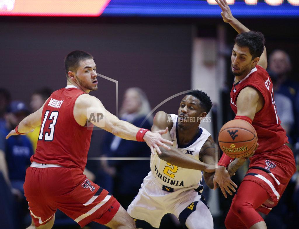 Ray Thompson Texas Tech guard Matt Mooney (13) and guard Davide Moretti (25) trap West Virginia guard Brandon Knapper (2) during the second half of an NCAA college basketball game Wednesday, Jan. 2, 2019, in Morgantown, W.Va. Texas Tech defeated West Virginia 62-59. (AP Photo/Raymond Thompson)