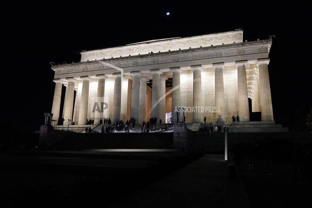 Jacquelyn Martin Vice President Kamala Harris and her husband Doug Emhoff wait at the Lincoln Memorial for fireworks to begin Wednesday, Jan. 20, 2021, in Washington. (AP Photo/Jacquelyn Martin)