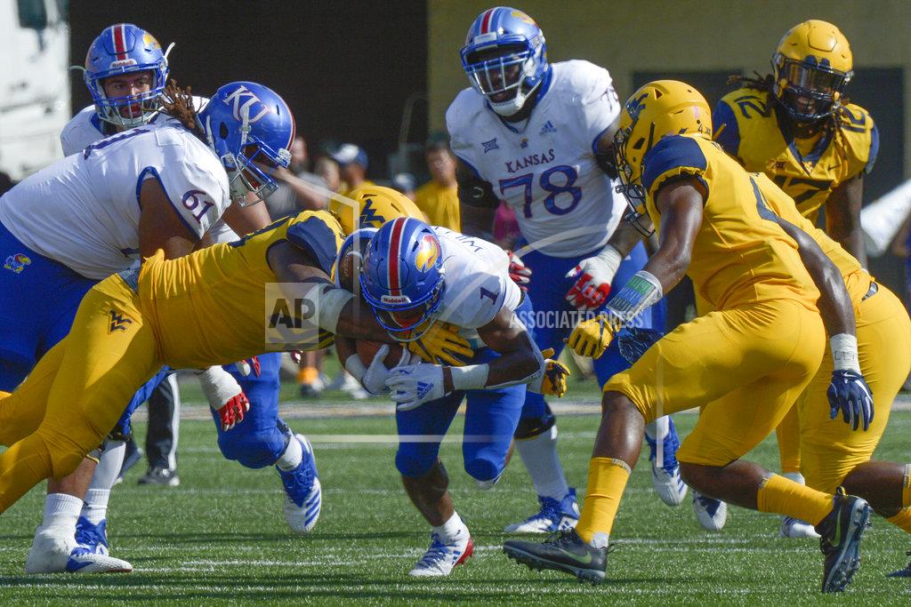 Craig Hudson Kansas running back Pooka Williams Jr. (1) is tackled during the second half of an NCAA college football game against West Virginia in Morgantown, W. Va., Saturday Oct. 6, 2018. (AP Photo/Craig Hudson)