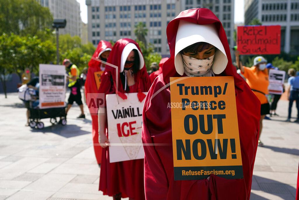 Marcio Jose Sanchez Demonstrators wear costumes and hold signs during a Women's March Saturday, Oct. 17, 2020, in Los Angeles. Thousands of women rallied in U.S. cities, to oppose President Donald Trump and his fellow Republican candidates in the Nov. 3 elections. (AP Photo/Marcio Jose Sanchez)