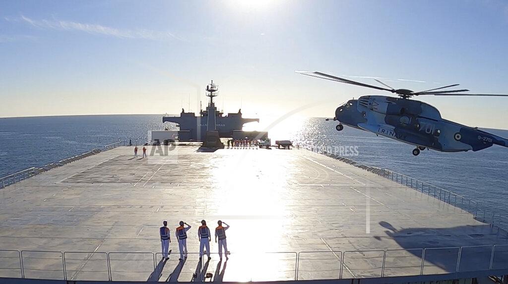 Uncredited This image made from a video released on Wednesday, Jan. 13, 2021, by the Iranian Army shows a helicopter landing on Makran logistics vessel during a navy drill. Iran's navy began a short-range missile drill in the Gulf of Oman on Wednesday, state TV reported, amid heightened regional tensions over Tehran's nuclear program and a U.S. pressure campaign against the Islamic Republic. (Iranian Army via AP)
