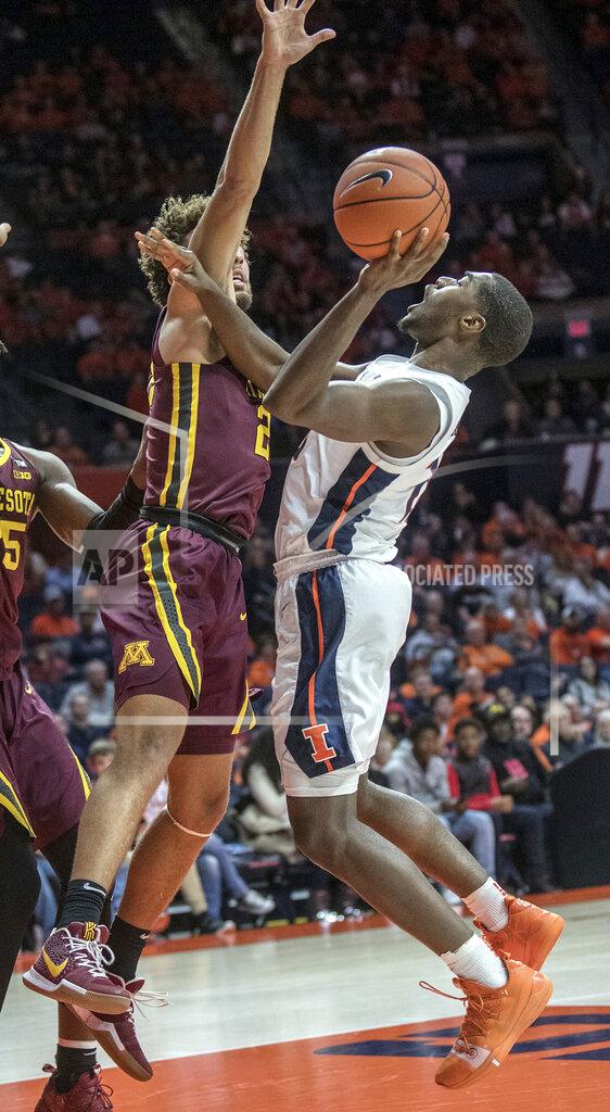Rick Danzl Illinois guard Da'Monte Williams (20) tries to muscle up a shot on Minnesota guard Gabe Kalscheur (22) during the first half of an NCAA college basketball game in Champaign, Ill., Wednesday, Jan. 16, 2019. (AP Photo/Rick Danzl)