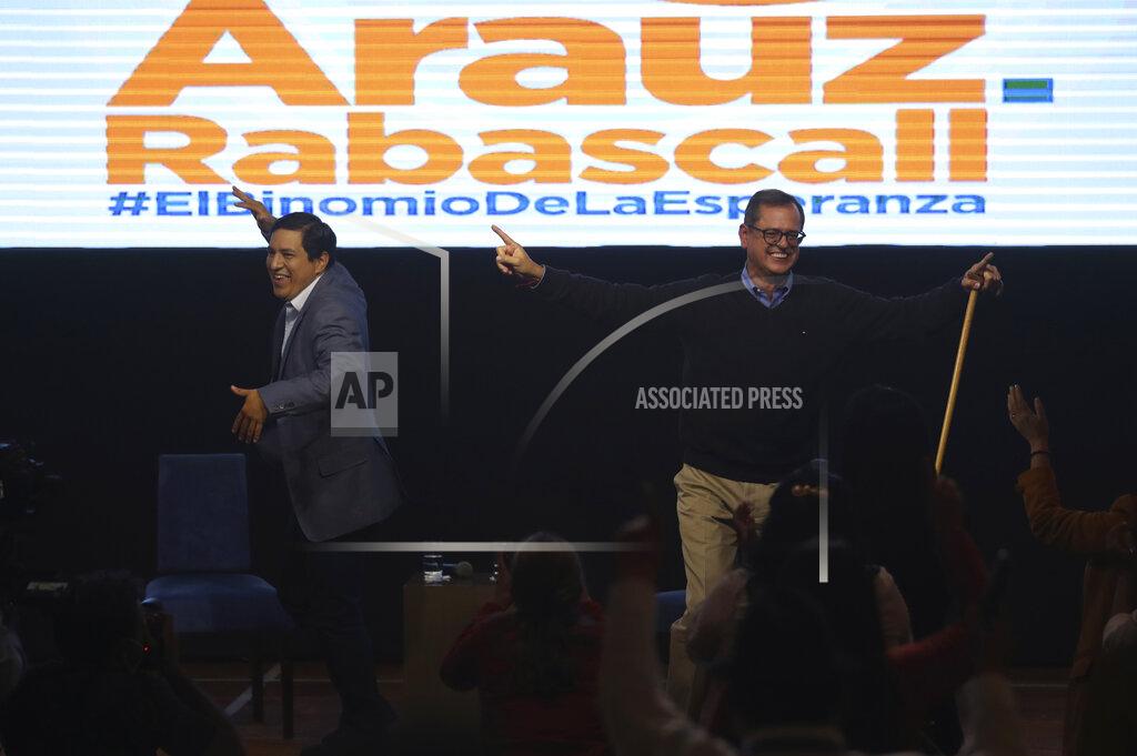 Dolores Ochoa Esperanza-UNES- alliance party presidential candidate Andres Arauz, left, and his running mate Carlos Rabascall celebrate as they wait for the official results to know if they have reached the necessary percentage to win in the first electoral round, in Quito, Ecuador, Sunday, Feb. 7, 2021. (AP Photo/Dolores Ochoa)