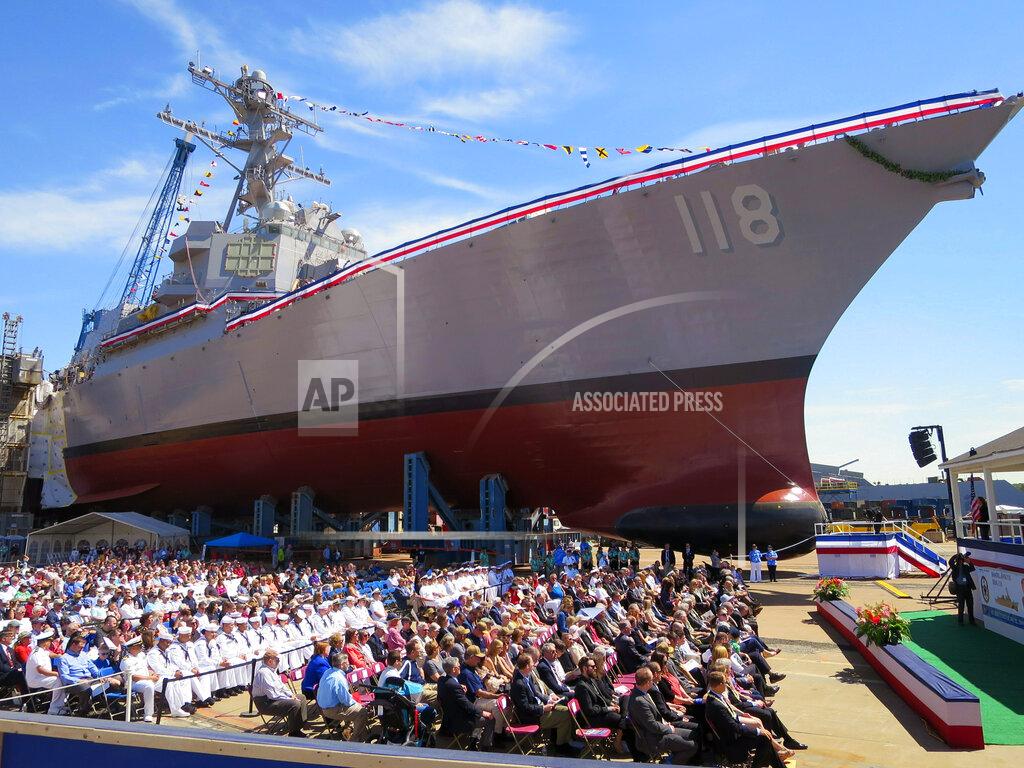 David Sharp FILE - In this Saturday, June 22, file photo, people attend the christening ceremony for the future USS Daniel Inouye at the shipbuilder Bath Iron Works in Bath, Maine. The return of shipbuilders after a nine-week strike, which officially ended Aug. 23, 2020, is going smoothly at Bath Iron Works and the union and company already have begun meeting to get back on track. (AP Photo/David Sharp)