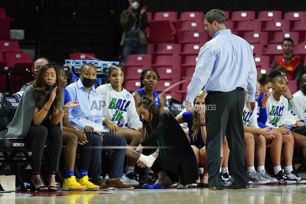 Julio Cortez Florida Gulf Coast head coach Karl Smesko, top, looks on as guard Tishara Morehouse has her leg taped up during the second half of a college basketball game against Maryland in the second round of the NCAA tournament, Sunday, March 20, 2022, in College Park, Md. Maryland won 89-65. (AP Photo/Julio Cortez)