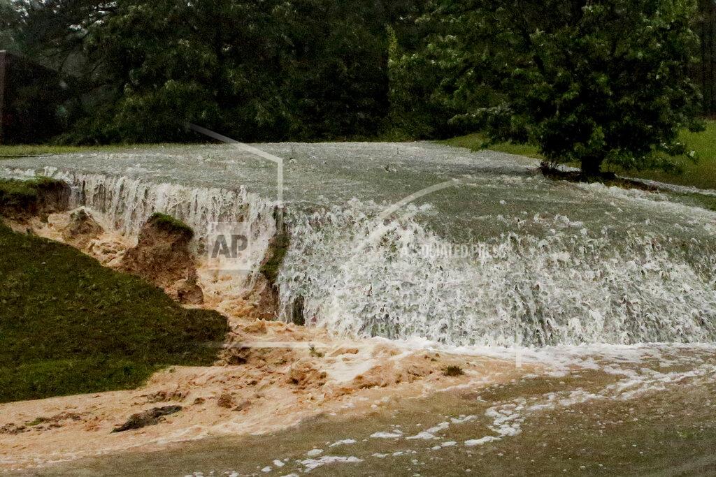 Butch Dill A hillside is eroded away as torrential rainfall falls Tuesday, May 4, 2021 in Vestavia, Ala. (AP Photo/Butch Dill)