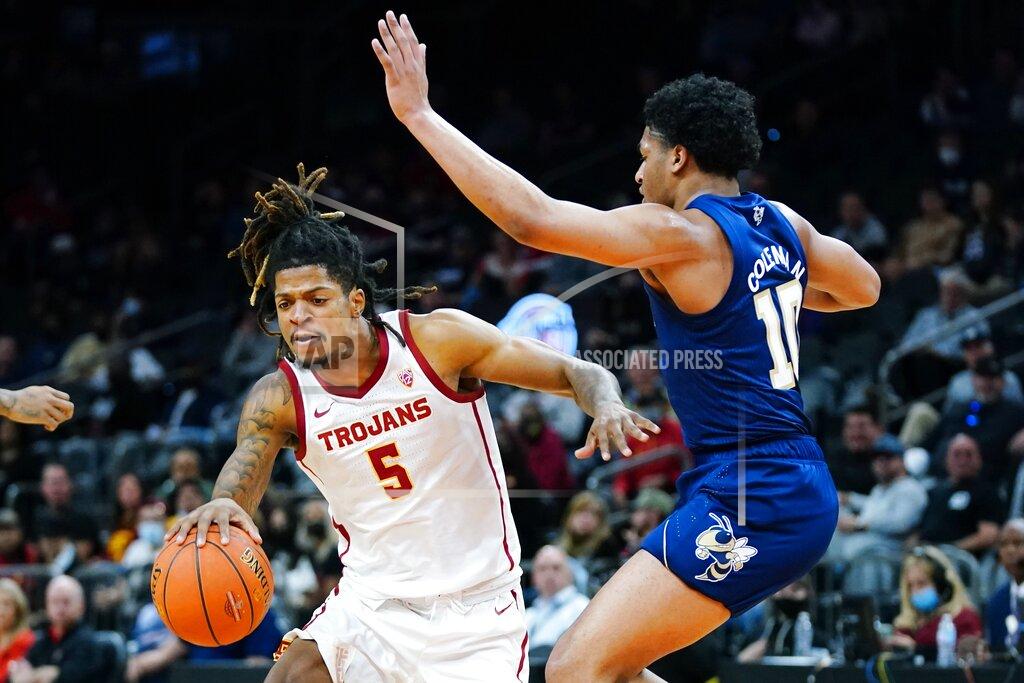 Ross D. Franklin Southern California guard Isaiah White (5) dribbles around Georgia Tech guard Dallan Coleman (10) during the first half of an NCAA college basketball game at the Jerry Colangelo Classic Saturday, Dec. 18, 2021, in Phoenix. (AP Photo/Ross D. Franklin)