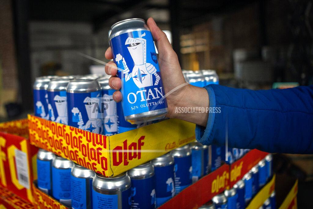 Soila Puurtinen Beer cans with writing OTAN inspired by the North Atlantic Treaty Organization (NATO) logo by Olaf Brewing Company are displayed in Savonlinna, eastern Finland, Tuesday, May 17, 2022. Sweden on Tuesday signed a formal request to join NATO, a day after the country announced it would seek membership in the 30-member military alliance. In neighboring Finland, lawmakers are expected later in the day to formally endorse Finnish leaders’ decision also to join. The moves by the two Nordic countries, ending Sweden’s more than 200 years of military nonalignment and Finland’s nonalignment after World War II, have provoked the ire of the Kremlin. (Soila Puurtinen/Lehtikuva via AP)