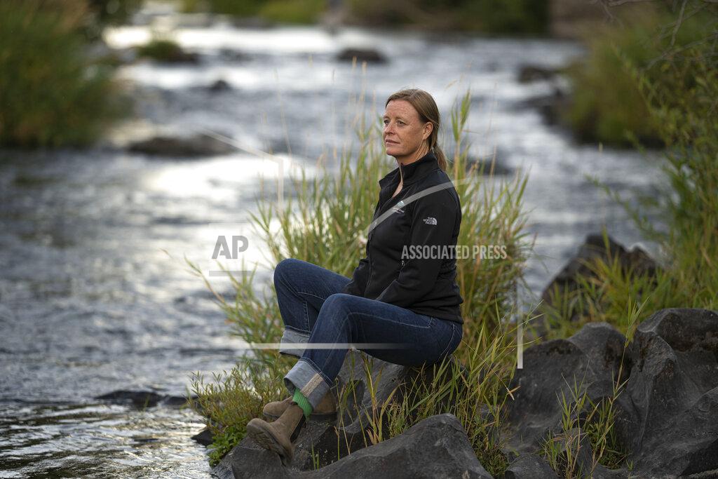 Nathan Howard Kate Fitzpatrick, the executive director of the Deschutes River Conservancy, poses for a press photo along the banks of the middle Deschutes River on Tuesday, Aug. 31, 2021, in Bend, Ore. "We're trying to figure out ways for water to move around more flexibly," she said. "If we can find those win-win solutions, I believe that the Deschutes can be a model for the West as the West faces increasing drought and scarcity and population growth." (AP Photo/Nathan Howard)