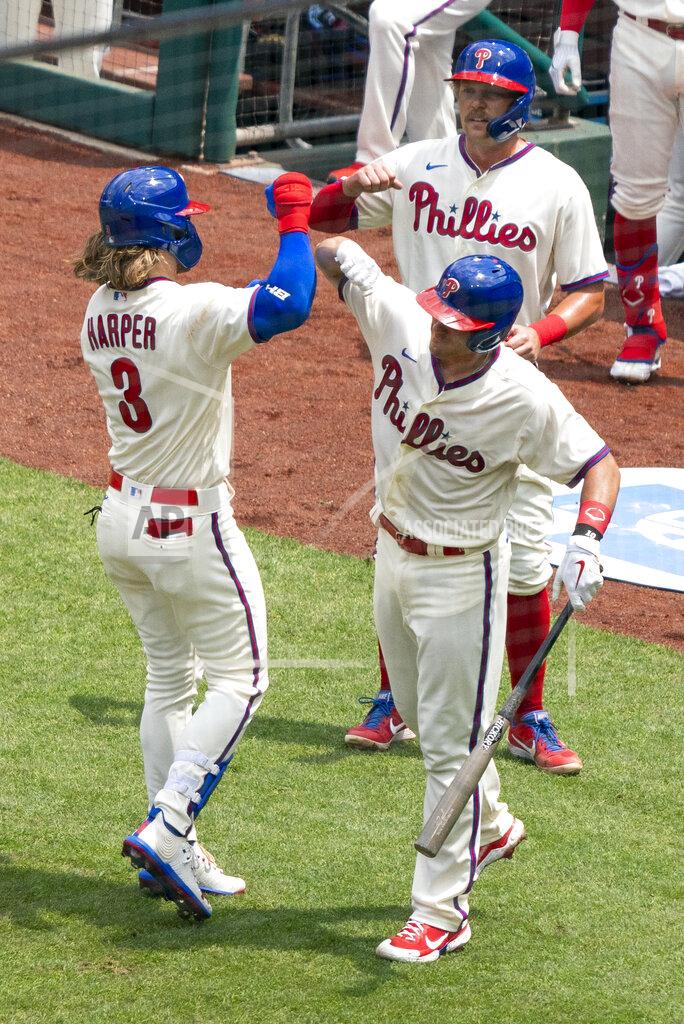 Chris Szagola Philadelphia Phillies' Bryce Harper, left, celebrates his three-run home run with J.T. Realmuto, right, during the first inning of a baseball game against the Miami Marlins, Sunday, July 26, 2020, in Philadelphia. (AP Photo/Chris Szagola)