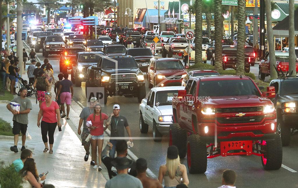 David Tucker In this June 12, 2021 photo, Daytona Truck Meet, enthusiasts pack Atlantic Avenue and sidewalk near the Ocean Center, in Daytona Beach, Fla. (David Tucker/The Daytona Beach News-Journal via AP)