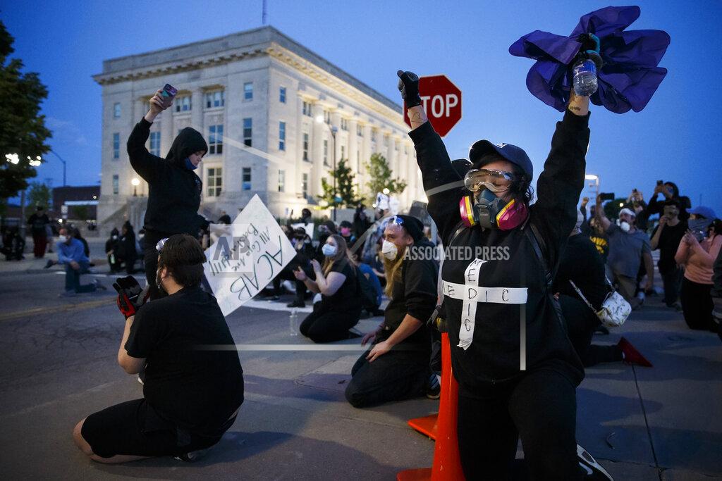 Brian Powers Protesters cheer after police officers joined them in taking a knee in front of the Des Moines Police Station in an act of solidarity on Sunday, May 31, 2020 in Des Moines. The protest was peacefully dispersed shortly thereafter. (Brian Powers/The Des Moines Register via AP)