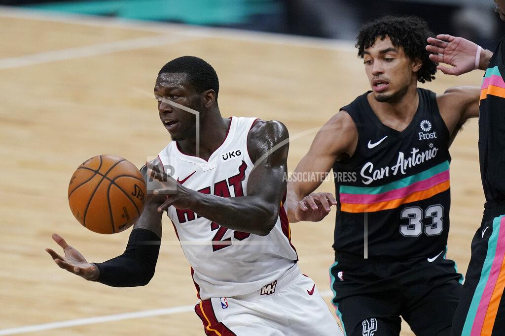 Eric Gay Miami Heat guard Kendrick Nunn (25) moves the pall past San Antonio Spurs guard Tre Jones (33) during the second half of an NBA basketball game in San Antonio, Wednesday, April 21, 2021. (AP Photo/Eric Gay)