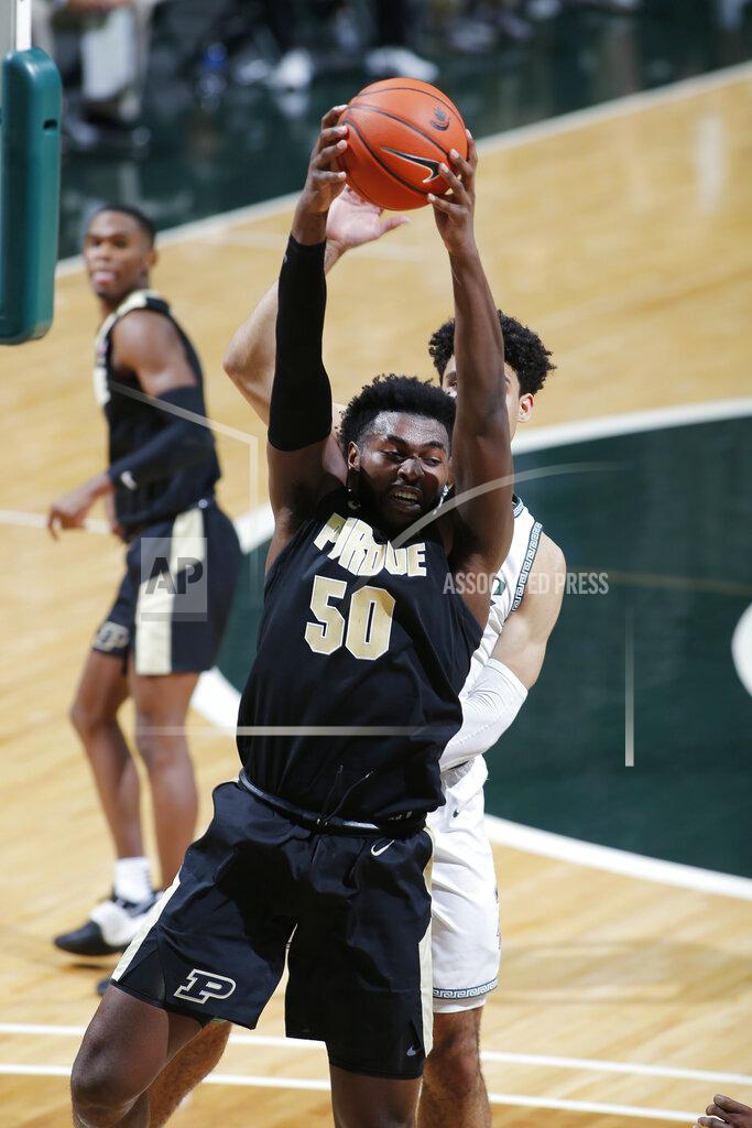 Al Goldis Purdue's Trevion Williams (50) pulls down a rebound in front of Michigan State's Malik Hall during the second half of an NCAA college basketball game, Friday, Jan. 8, 2021, in East Lansing, Mich. (AP Photo/Al Goldis)