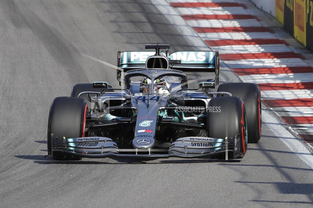 Luca Bruno Mercedes driver Lewis Hamilton of Britain, center steers his racer during the qualifying session practice at the 'Sochi Autodrom' Formula One circuit, in Sochi, Russia, Saturday, Sept.28, 2019. The Formula one race will be held on Sunday. (AP Photo/Luca Bruno)