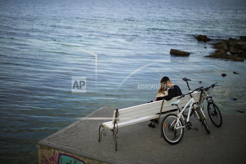 Francisco Seco A couple sit on a bench in Odesa, Ukraine, Tuesday, May 17, 2022. (AP Photo/Francisco Seco)