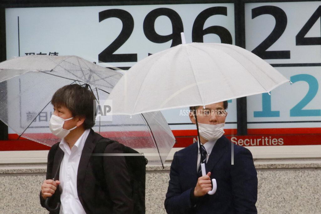 Koji Sasahara People wearing face masks stand by an electronic stock board of a securities firm in Tokyo, Wednesday, April 14, 2021. Asian stock markets rose Wednesday after Wall Street hit a high following an uptick in U.S. inflation and an order by regulators to suspend use of Johnson & Johnson's coronavirus vaccine. (AP Photo/Koji Sasahara)