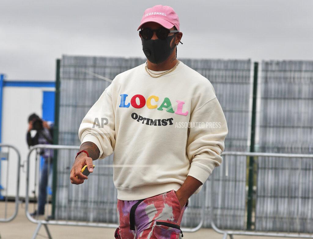 Frank Augstein Mercedes driver Lewis Hamilton of Britain arrives at the paddocks for preparations before the 70th Anniversary Formula One Grand Prix at the Silverstone circuit, Silverstone, England, Thursday, Aug. 6, 2020.(AP Photo/Frank Augstein)